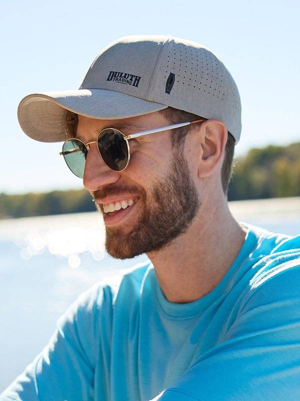 A man in a blue shirt wearing a baseball hat