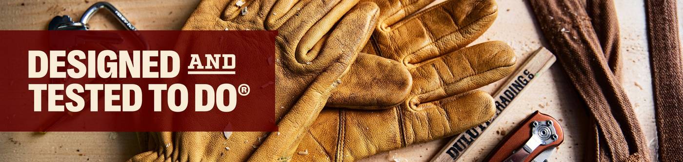 Headline: Designed and Tested to Do®. Yellow work gloves on work bench.