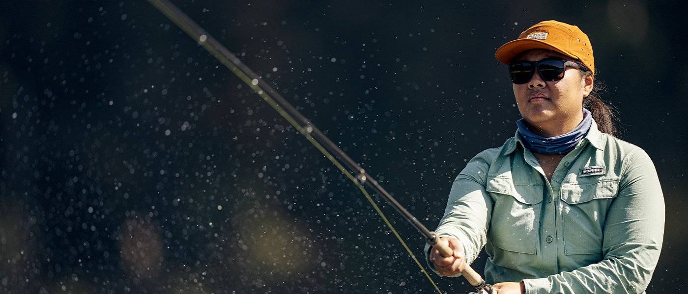 Kat casting fishing line; wearing crooked river shirt