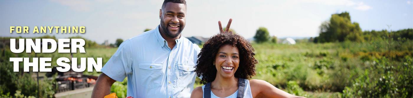 Man and woman standing in field.
