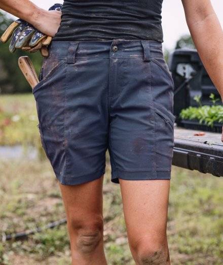 Woman wearing navy shorts.