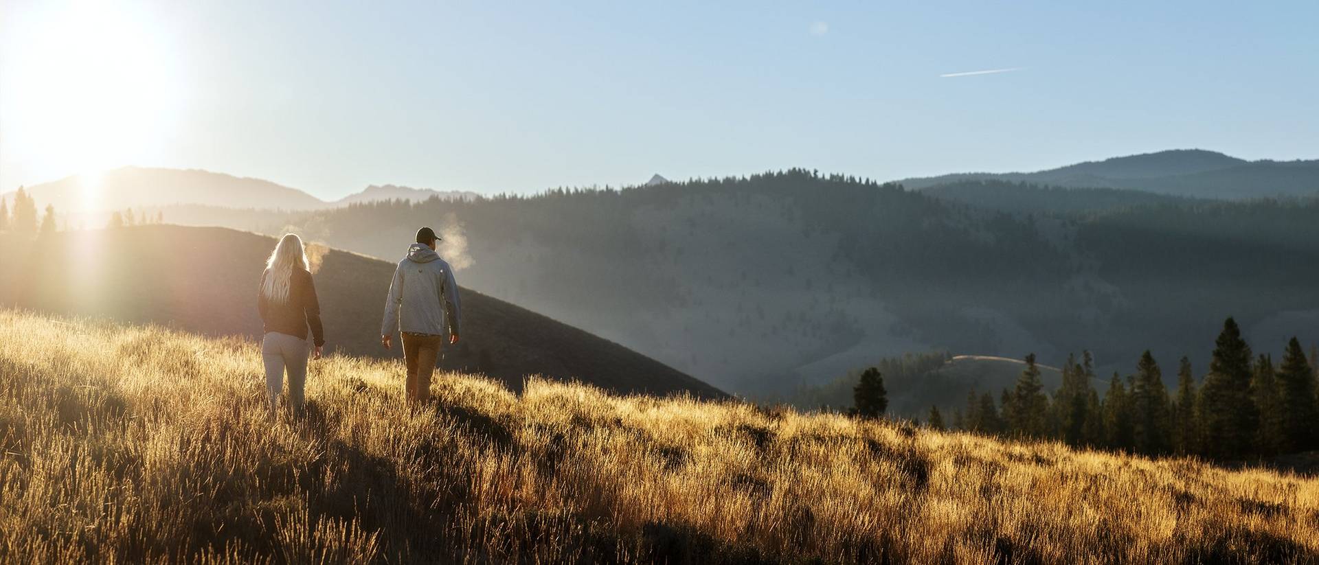 Man and woman hiking on mountain.