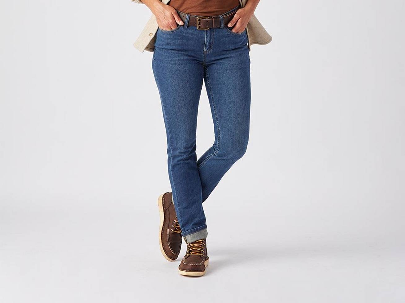 lower half of woman wearing blue jeans