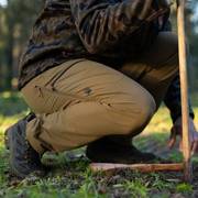 Man wearing tan pants, crouching