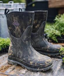 Muddy garden boots in the back of a pick-up truck