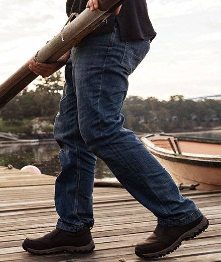 A man in jeans on a pier