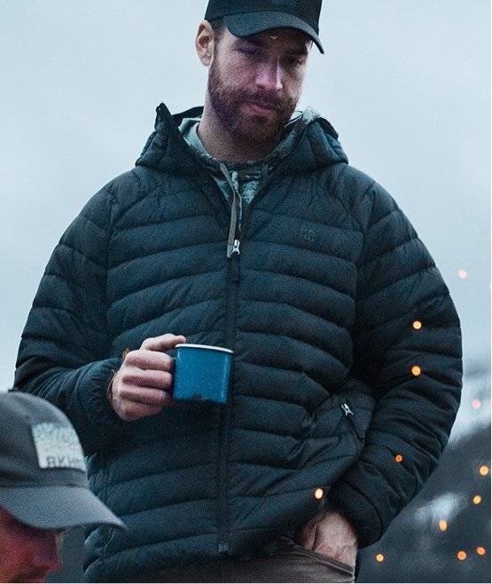 Man wearing navy puffer jacket.