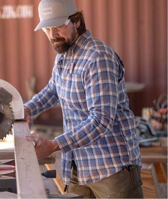Man wearing a flannel shirt.