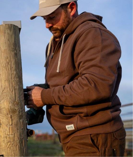 Man wearing a brown sweatshirt.