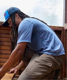 Man wearing a blue t-shirt.