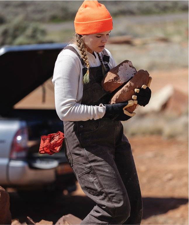 Woman wearing black overalls.