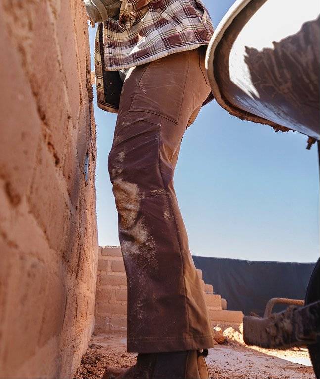 Woman wearing brown work pants.