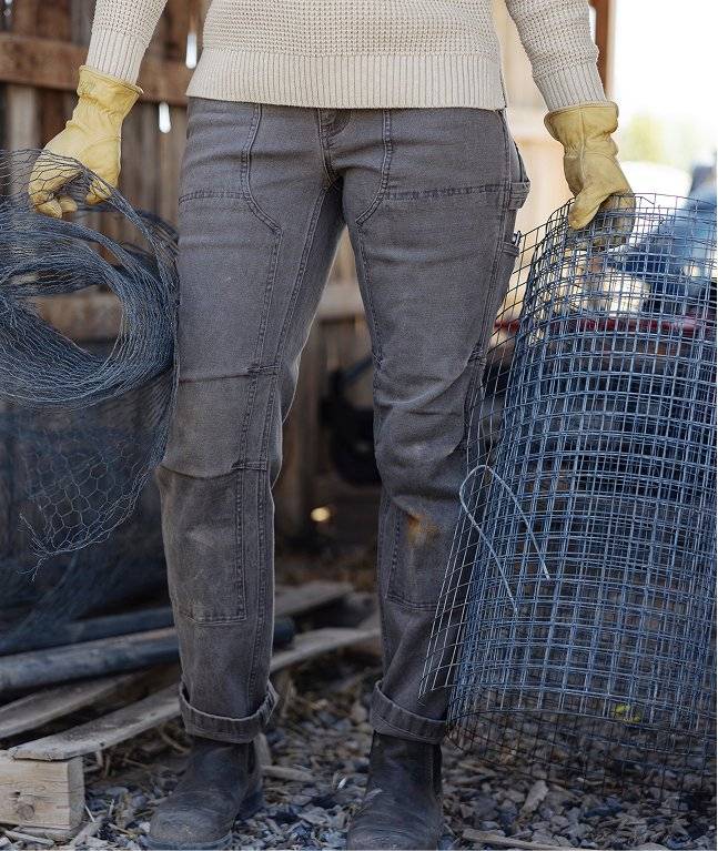 Woman wearing grey work pants.