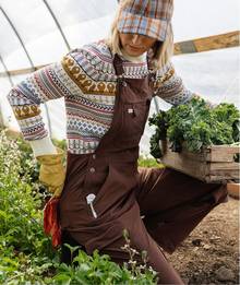 Woman wearing brown overalls.