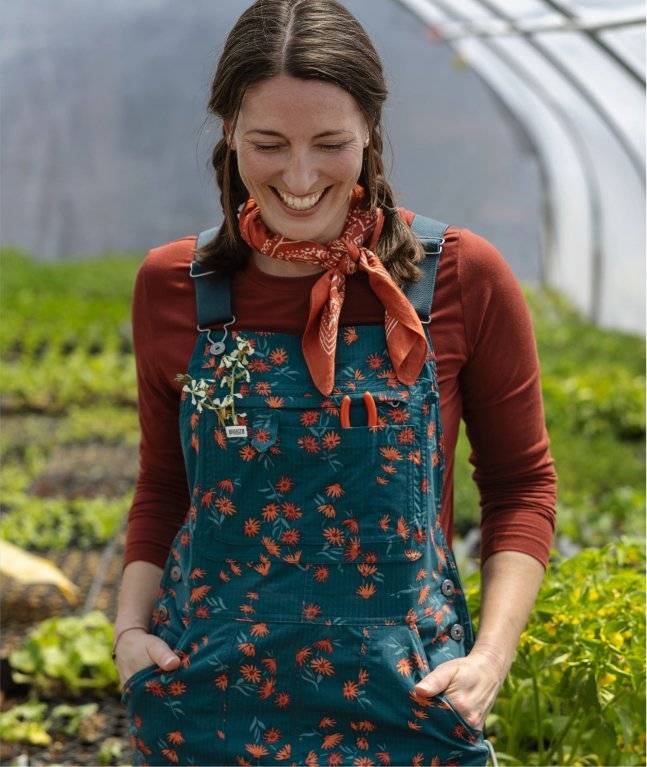 Woman wearing floral patterned overalls.