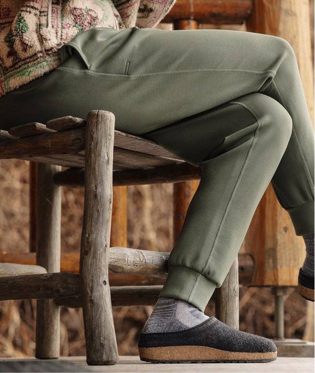 Woman wearing green lounge pants.