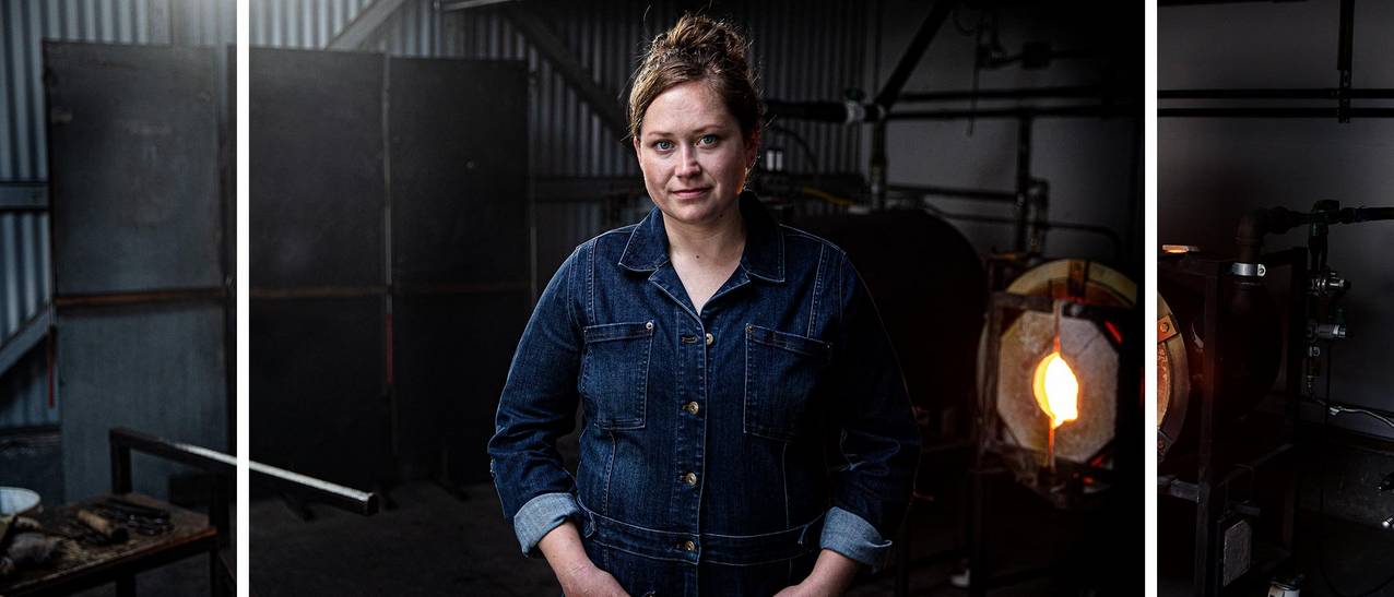 Caroline stands proudly in her glass blowing workshop