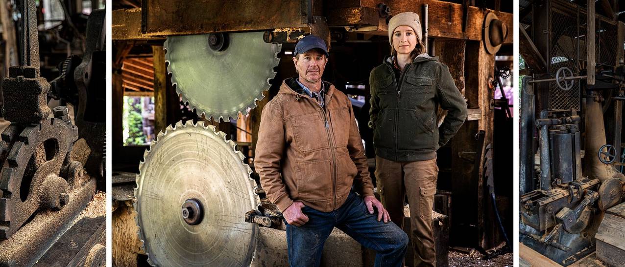 gregg & sarah stand proudly in front of their steam-powered lumber mill