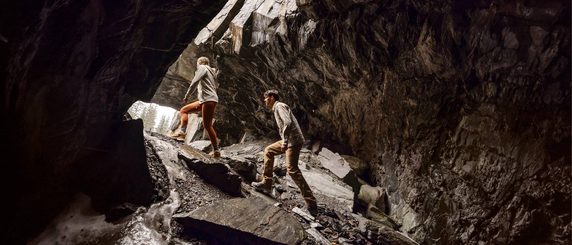 Man and woman hiking in cave.