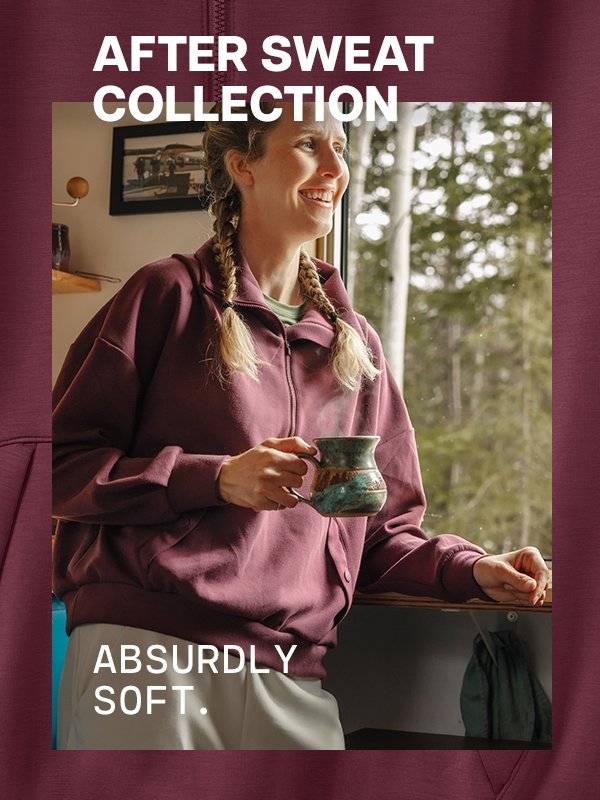 Woman drinking coffee in maroon half zip top.
