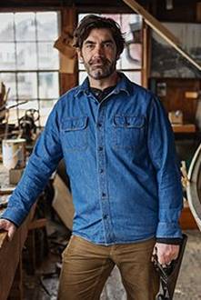 man in a long sleeved denim button down shirt