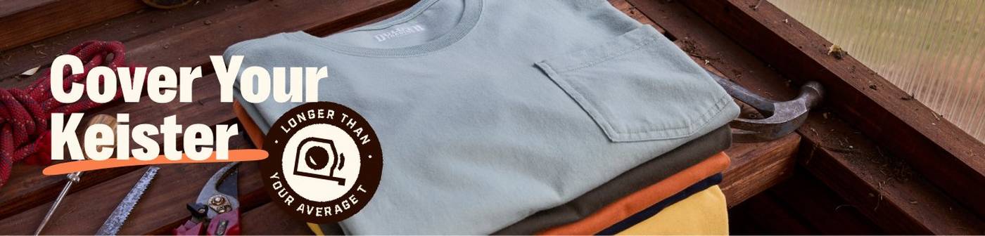 Headline: Cover Your Keister. Folded t-shirts on wood bench.