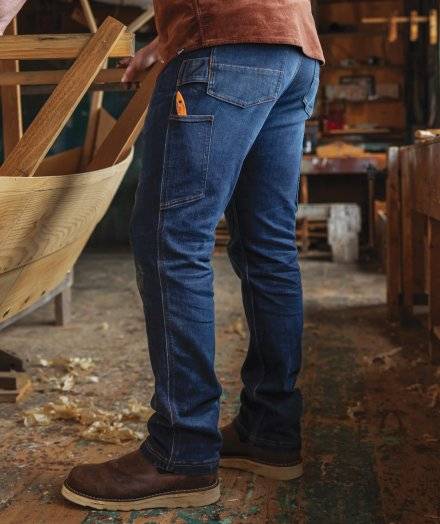 Man woodworking in jeans.