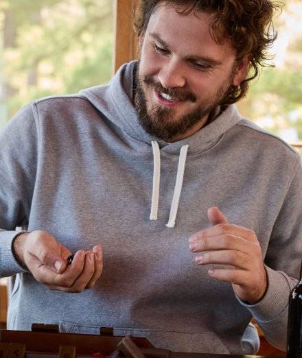 Man wearing grey sweatshirt.