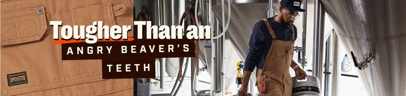 Man wearing Fire Hose® Overalls carrying keg of beer.