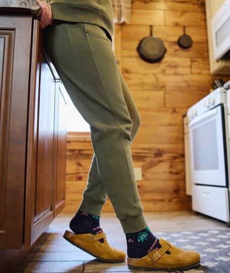 Woman wearing green jogger sweatpants.