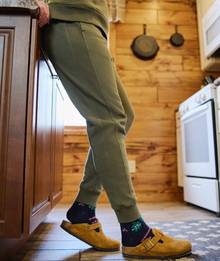 Woman wearing green jogger sweatpants.