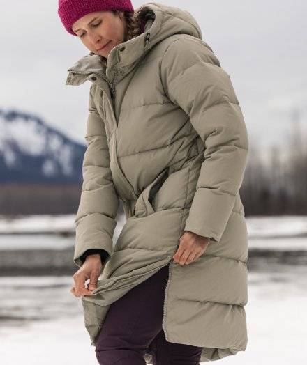 Woman wearing long tan parka.