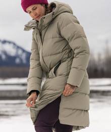 Woman wearing long tan parka.