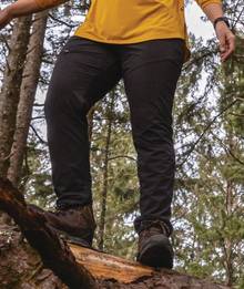 Woman wearing black pants, hiking.