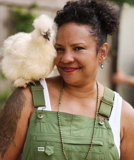 Woman with chicken on her shoulder.