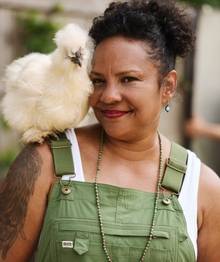 Woman with chicken on her shoulder.