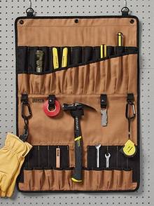 A brown tool bag hanging on a wall with tools in it