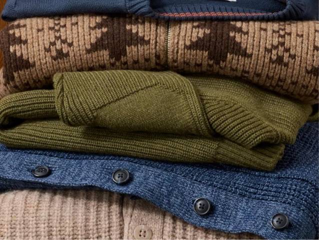 Folded sweaters stacked in a pile