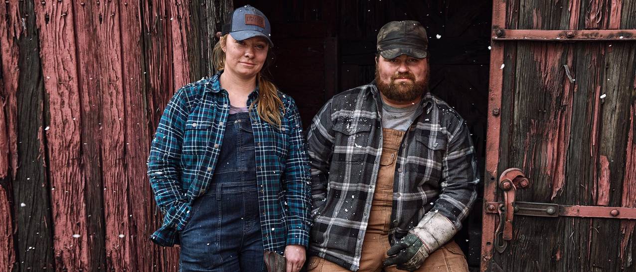 kylah and nick stand in the open door of a railcar smiling