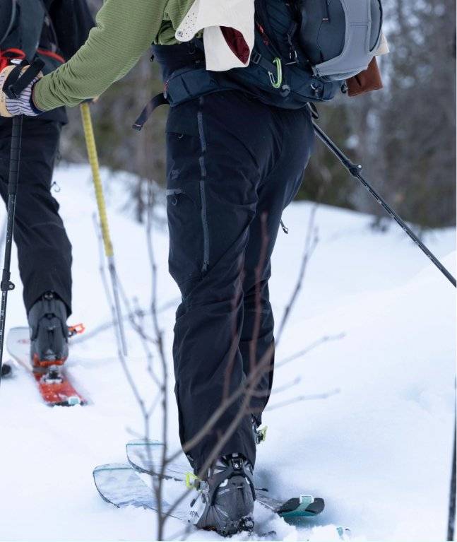 Man snowshoeing, wearing insulated pants