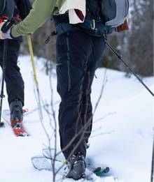 Man snowshoeing, wearing insulated pants