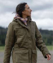 Woman wearing a green jacket.