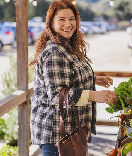 A woman in a plaid flannel shirt jac