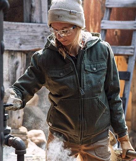 A woman in a green fire hose coat