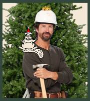Man wearing hard hat and holding a hammer, standing in front of a Christmas tree.