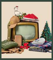 Television with clothing and merchandise stacked in piles.