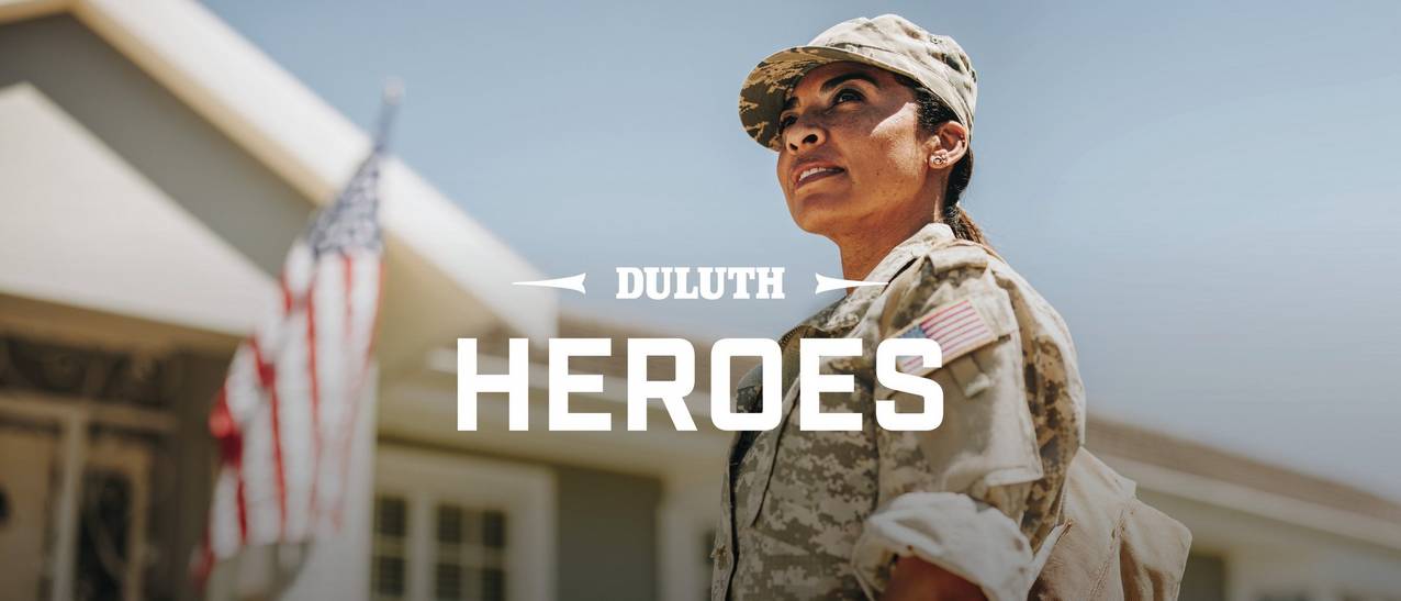 Woman in military uniform looks off into the distance