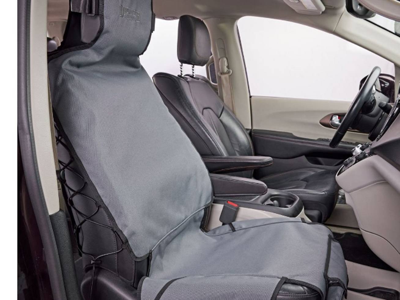 The interior of a car with a protective cover on the passenger seat.