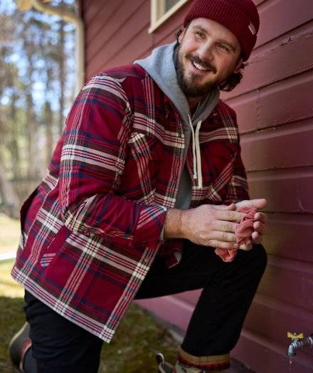 Man wearing a red flannel shirt jac.