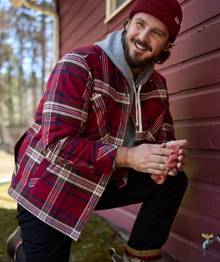 Man wearing a red flannel shirt jac.